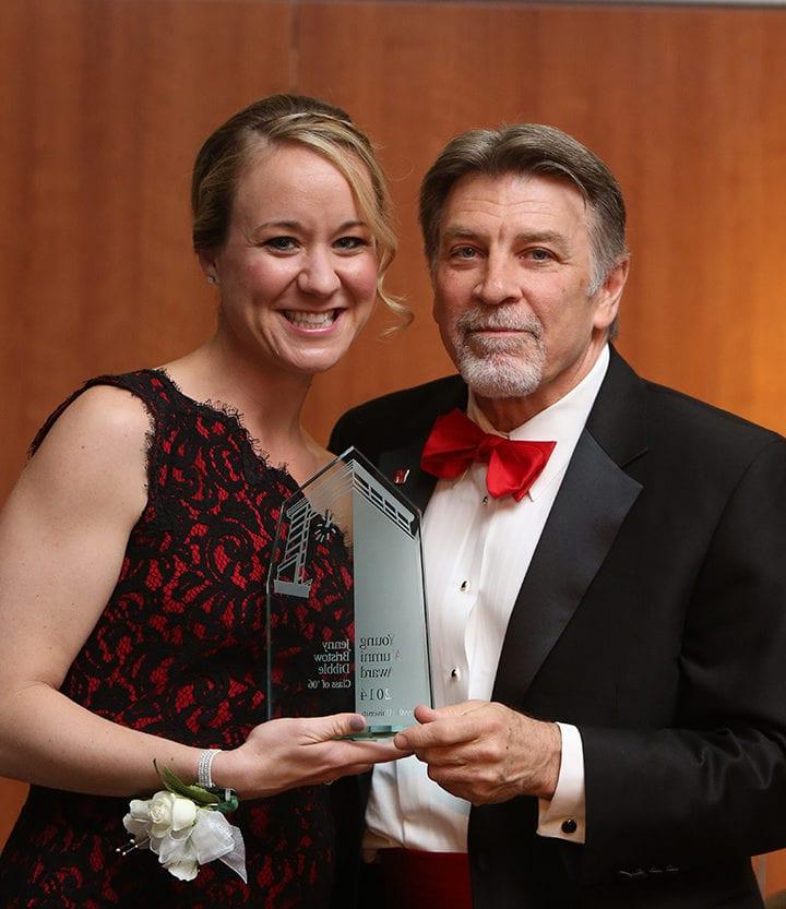 Jenny Bristow accepting a Spirit of Maryville award from Tom Eschen