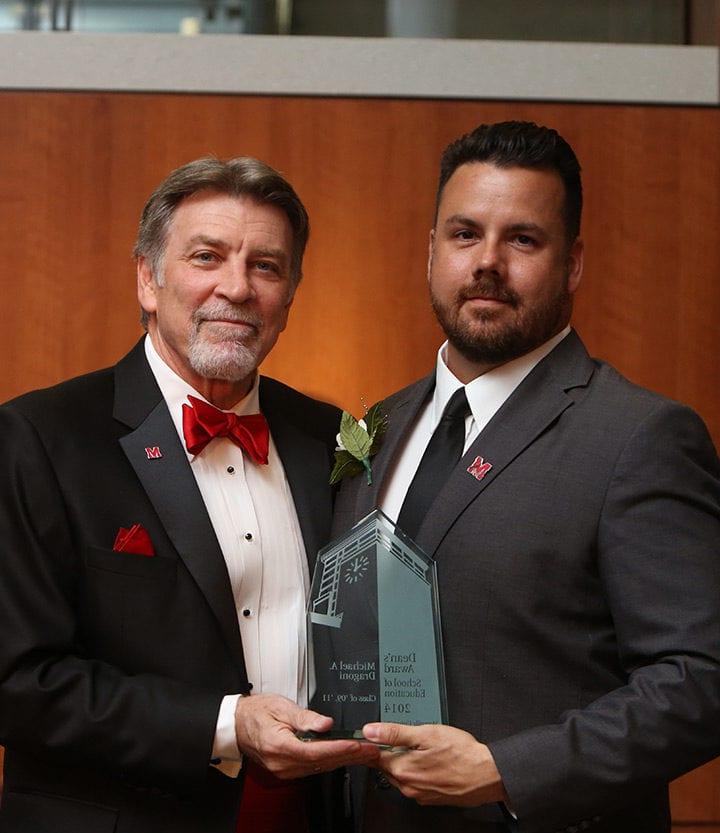 Michael Dragoni accepting a Spirit of Maryville award from Tom Eschen